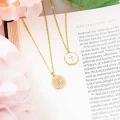 white monogrammed reversible cross necklace front and back on bible