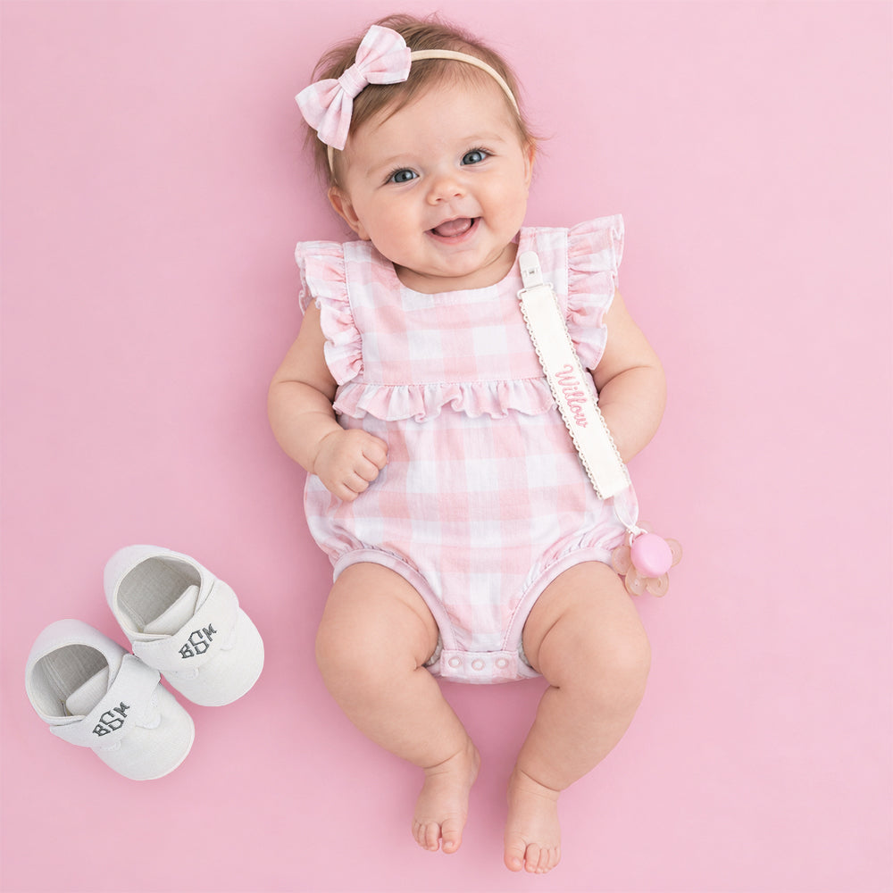 baby with white paci clip