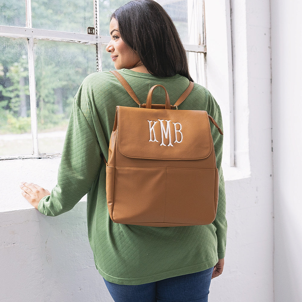 girl with monogrammed diaper backpack purse on back
