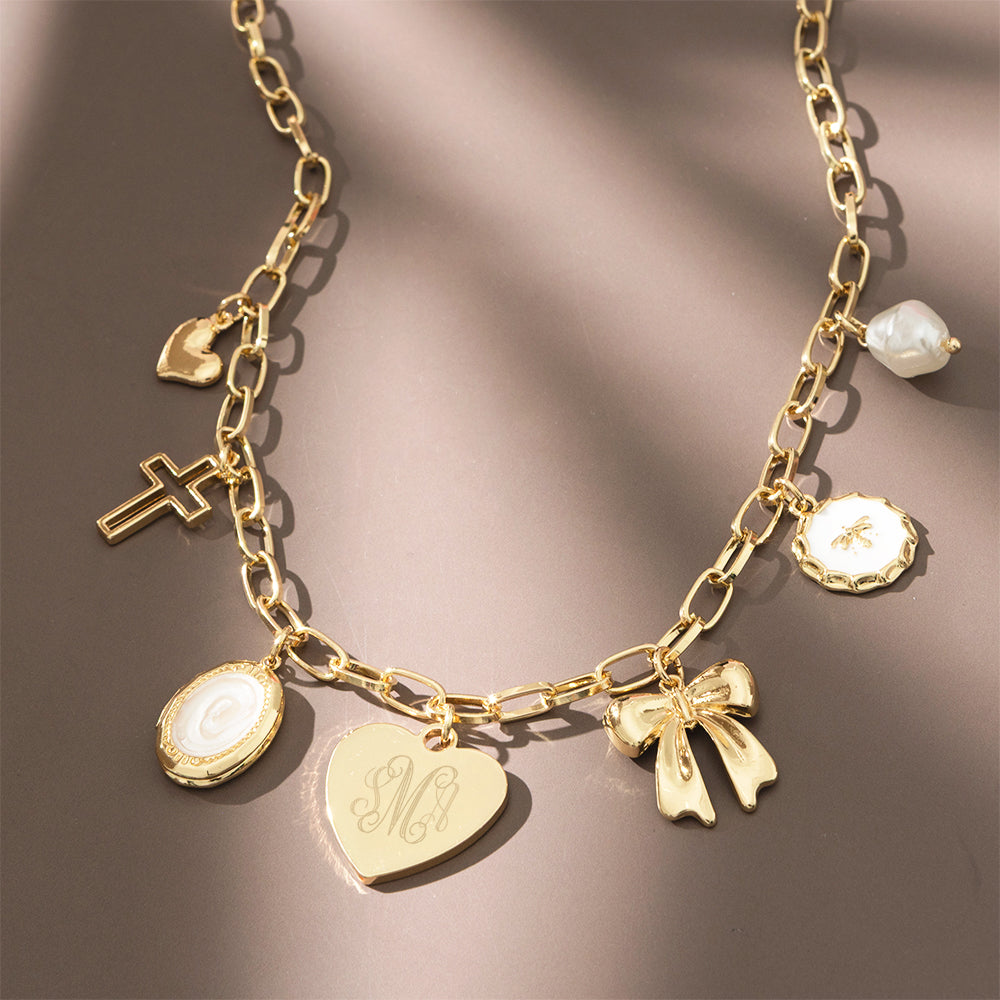 gold charm necklace on brown background