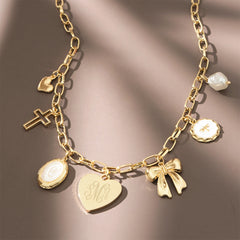 gold charm necklace on brown background