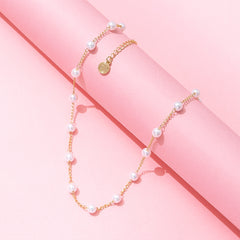 pearl station necklace on pink