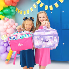 2 girls holding flower power and unicorn lunchboxes 