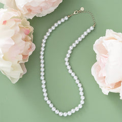 pearl necklace nm on green with flowers