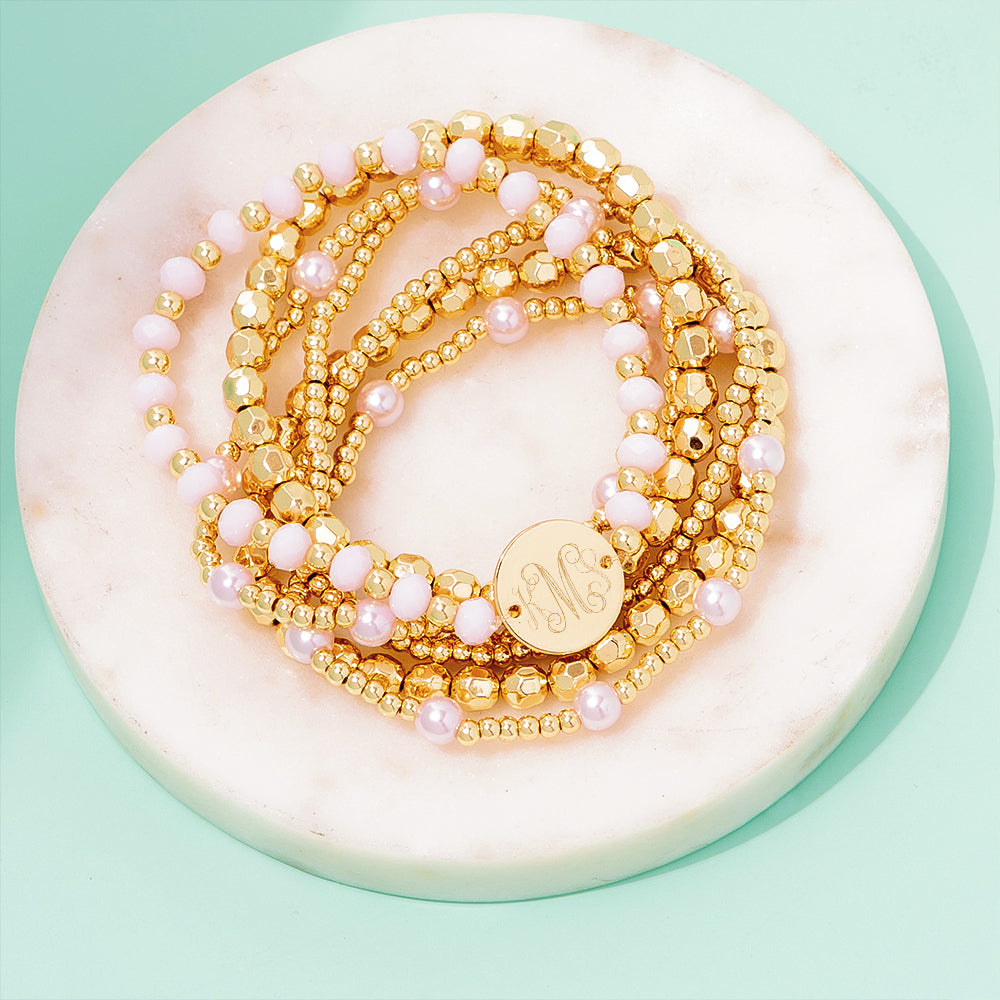 pink beaded monogrammed bracelet stack on marble