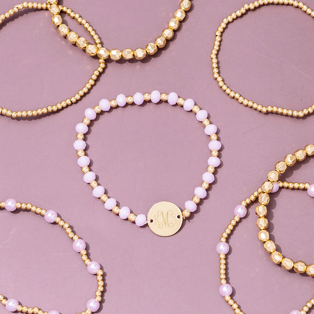 pink beaded monogrammed bracelets scattered