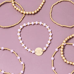 pink beaded monogrammed bracelets scattered