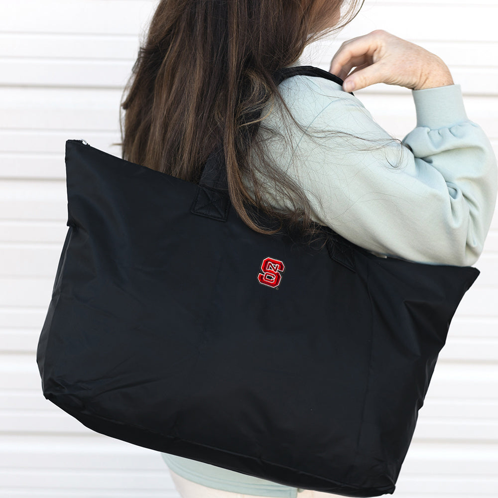 NC State Wolfpack Packable Duffel Bag on Shoulder