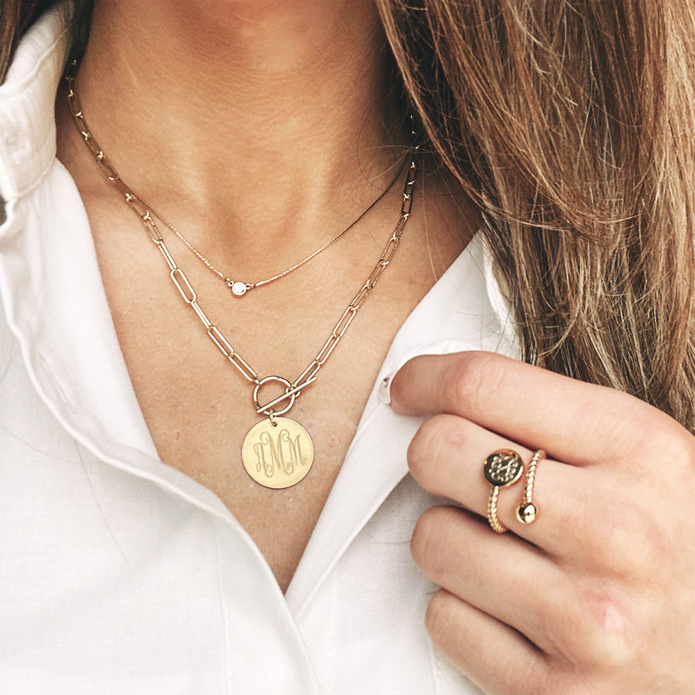 woman wearing gold pendant necklace