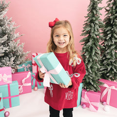 crimson kids sequin bow sweatshirt on girl with present