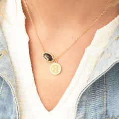 brown football necklace around neck