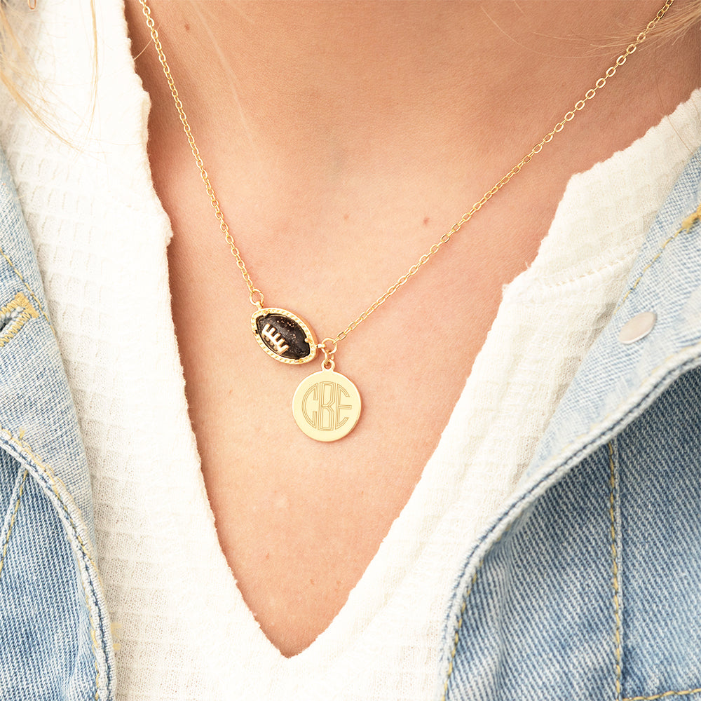 brown football necklace around neck