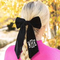 girl with hair braided with monogrammed velvet bow