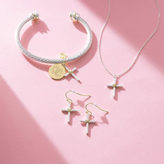 cable cross necklace bracelet and earrings on pink