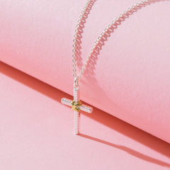 cable cross necklace detail shot on pink