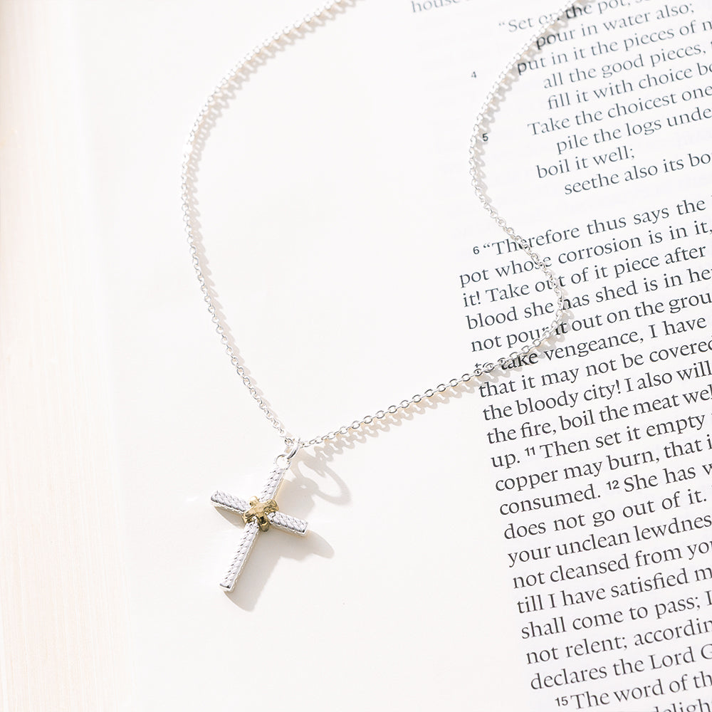 cable cross necklace on paper