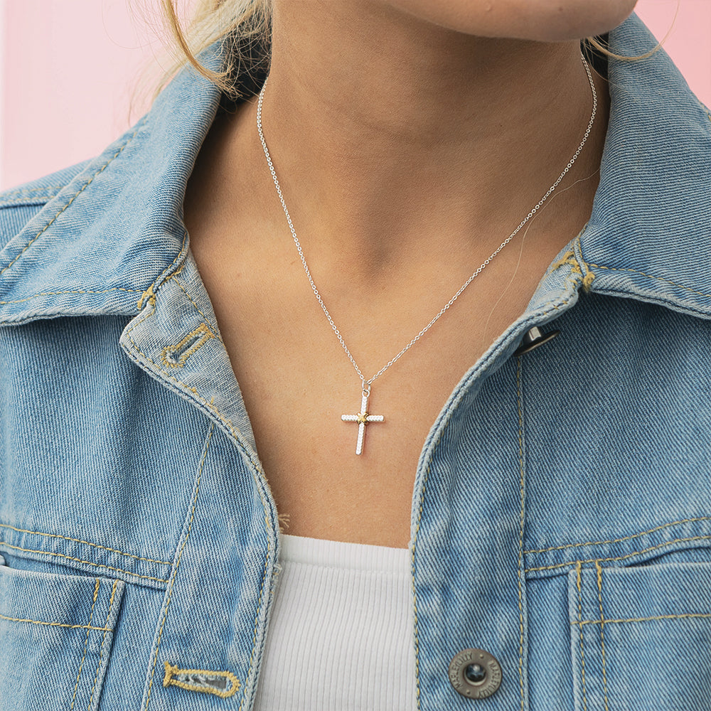 girl wearing cable cross necklace