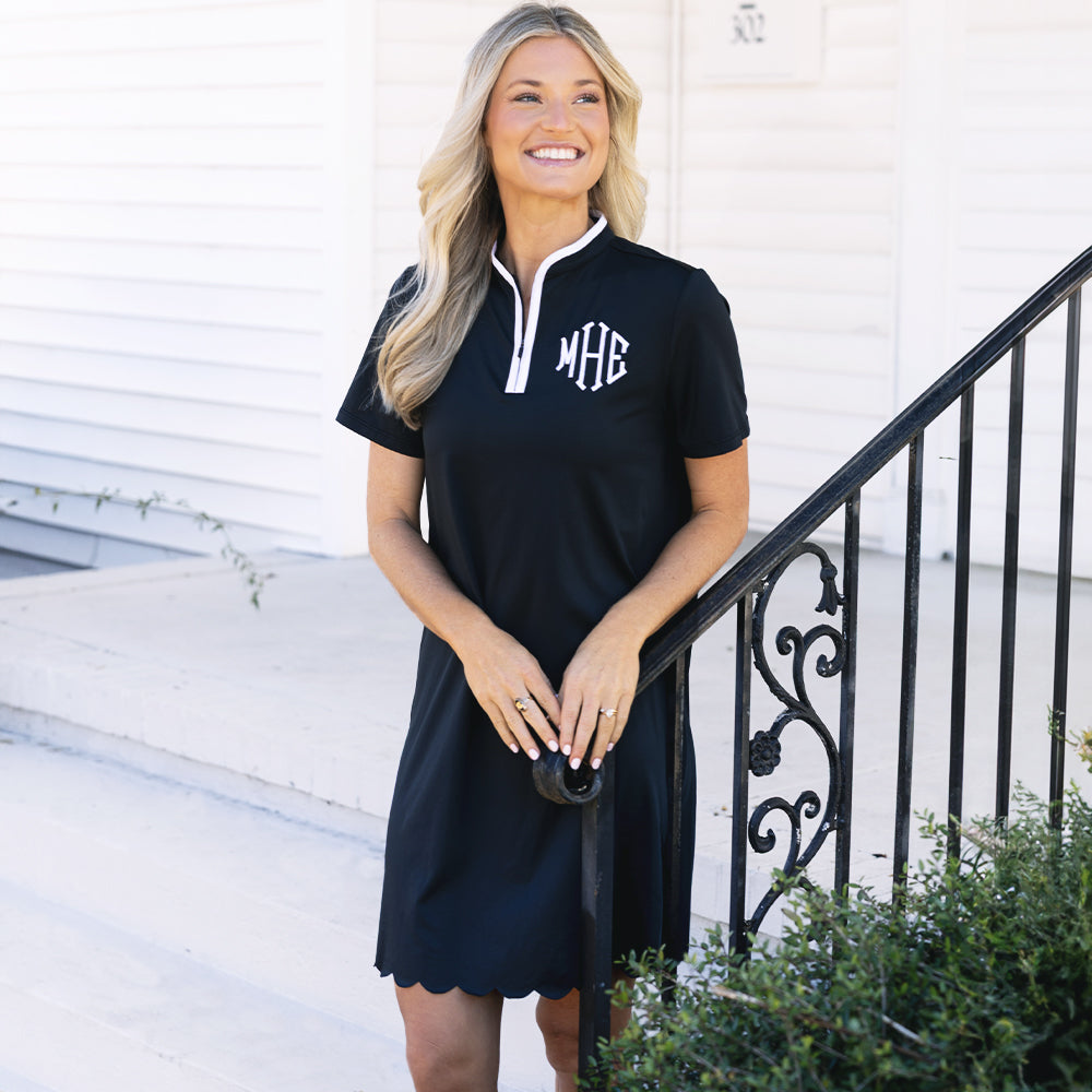 girl wearing monogrammed black quarter zip dress
