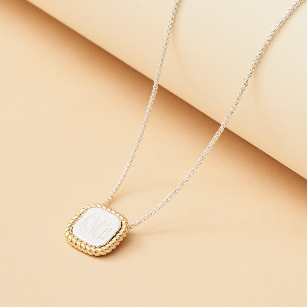 gold and silver cable pendant necklace with tan background