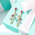 lights christmas earrings on gift box