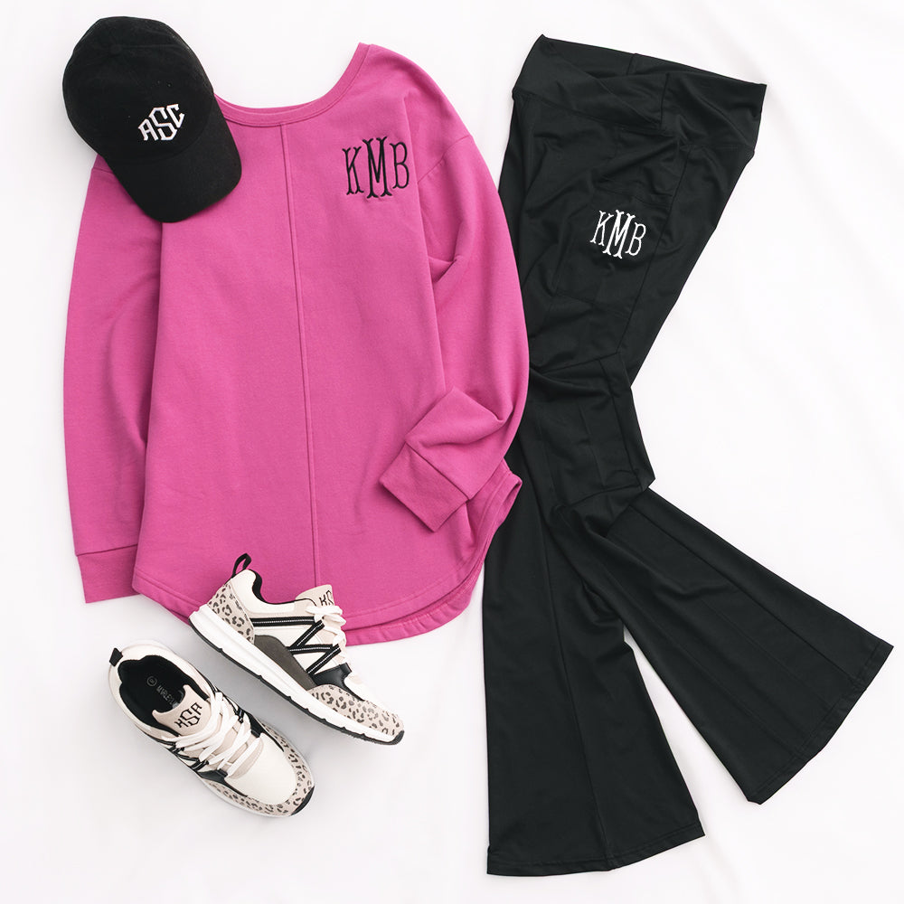 monogrammed sweatshirt and black flare leggings