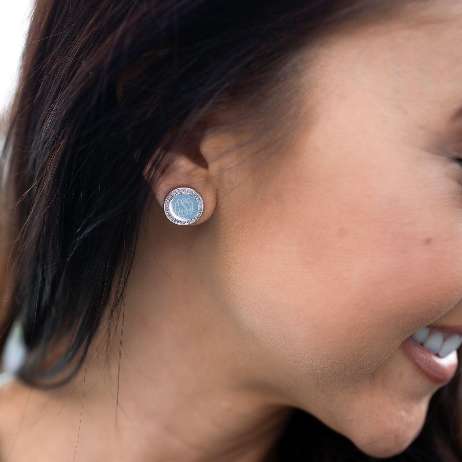 silver monogrammed disc earrings on brunette
