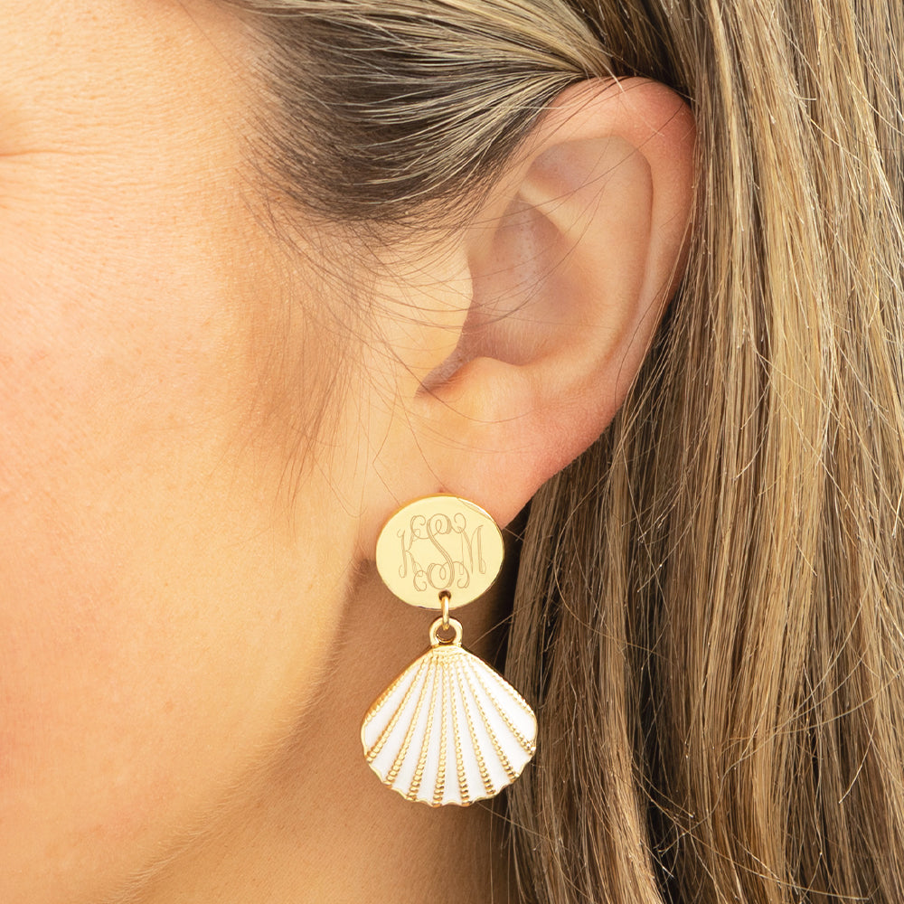 white shell earrings in ear