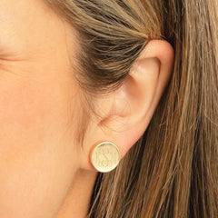 gold teacher earring set in ear