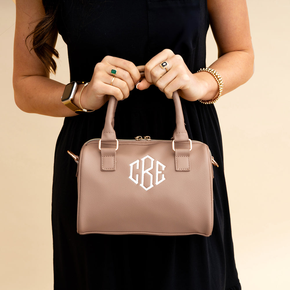 tan harper handbag being held by handles