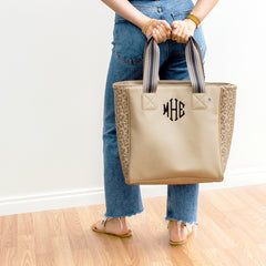 gold leopard tote purse held behind the back