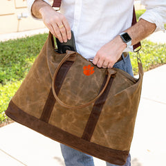 zipping open the clemson  waxed weekender bag - sp23