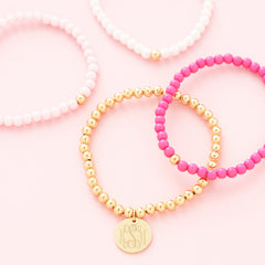 pink beaded bracelet set flatlay