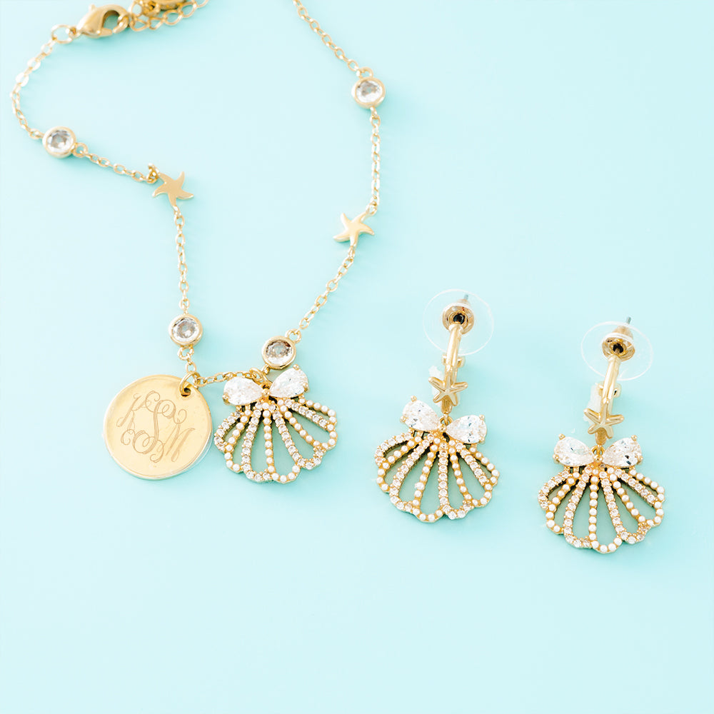 gold shell bracelet on blue background