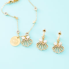 gold shell bracelet on blue background