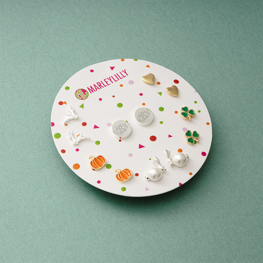 monogrammed year round earring set on green paper