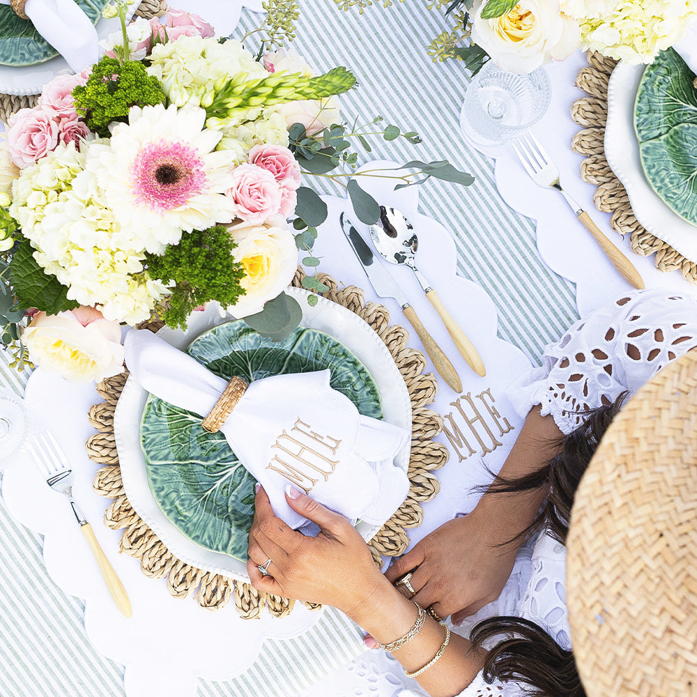 white scalloped placemat table with hands