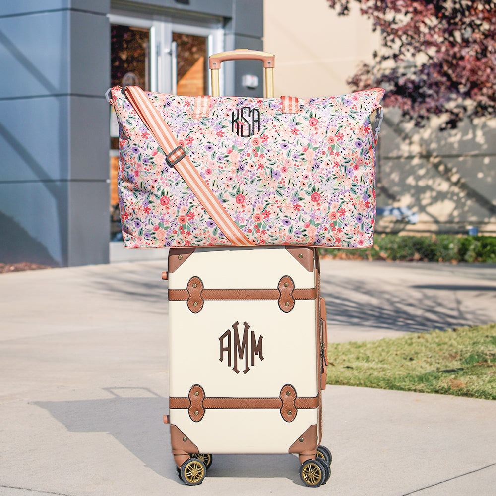 coral floral weekend bag on vintage suitcase
