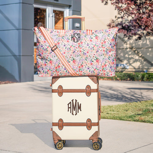 coral floral weekend bag on vintage suitcase