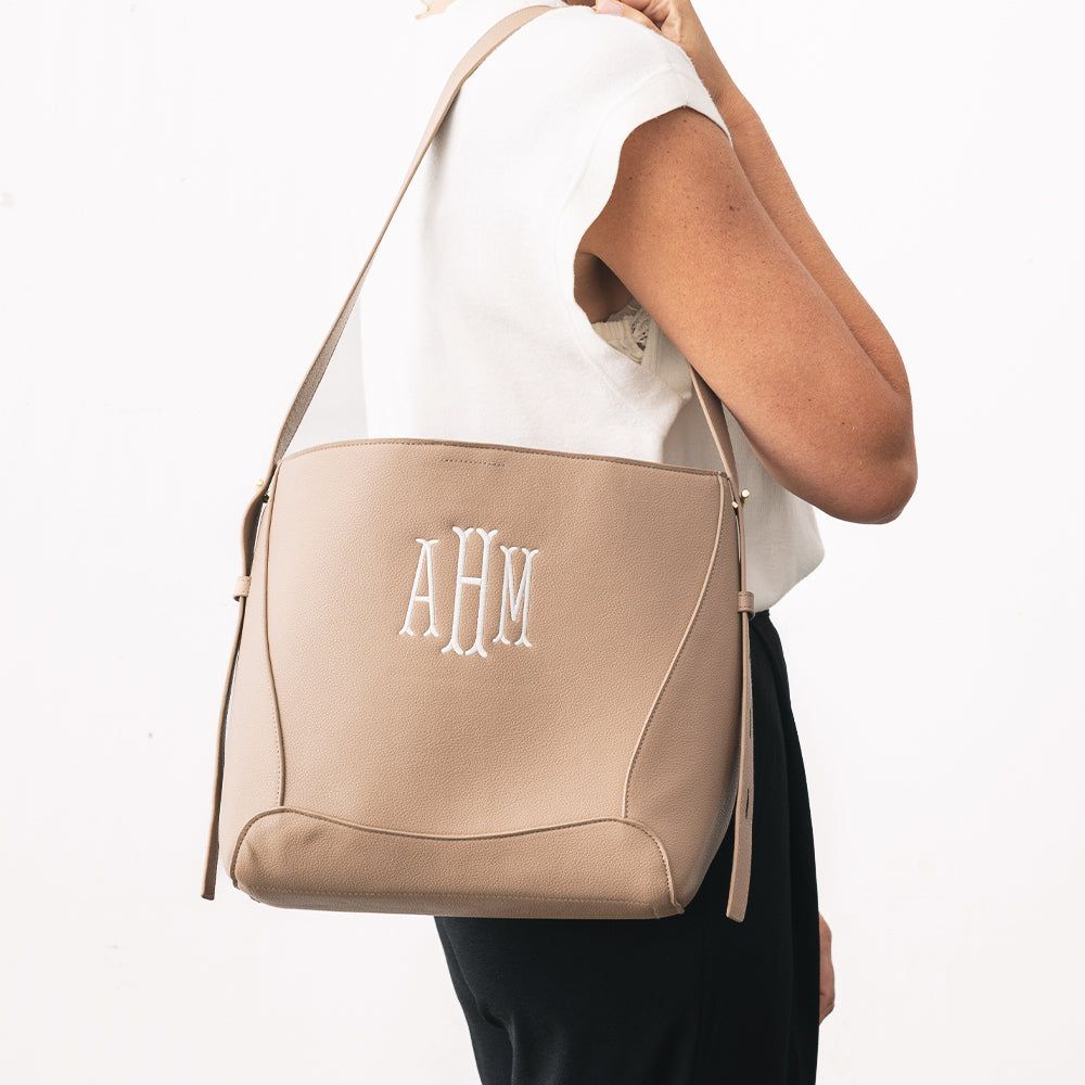 personalized bucket bag in taupe over shoulder