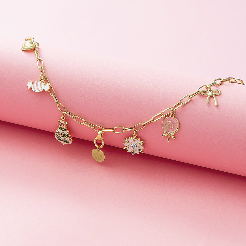 Christmas Charm Necklace flatlay on pink paper roll