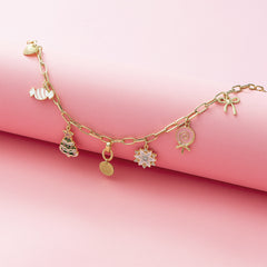 Christmas Charm Necklace flatlay on pink paper roll