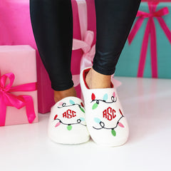 Christmas lights slippers on girl with presents