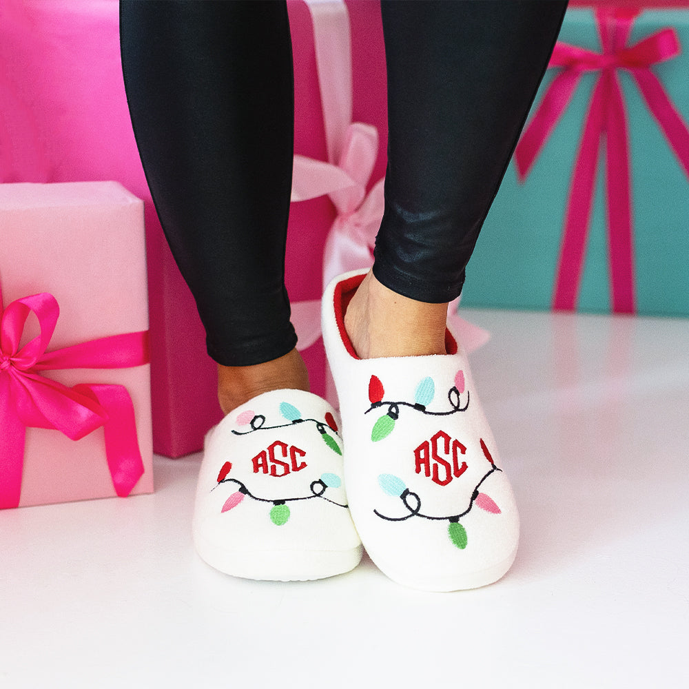 Christmas lights slippers on girl with presents