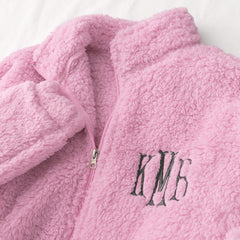 up close of light pink monogrammed full zip sherpa jacket