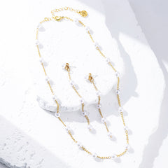pearl duster earrings and station necklace on marble flatlay