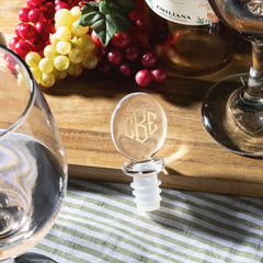 wine stopper on wooden table with grapes