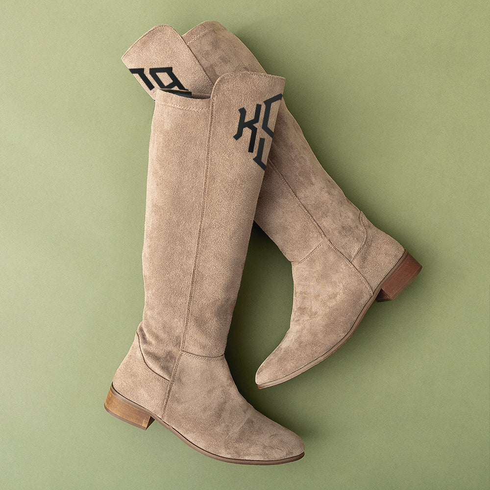 F26 tall riding boots in taupe flatlay on green