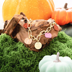 Fall charm bracelet on moss with pumpkins