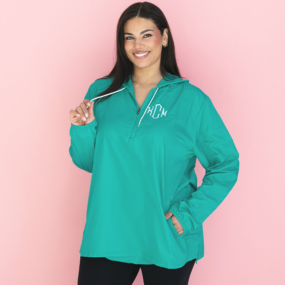 girl wearing teal monogrammed pullover rain jacket