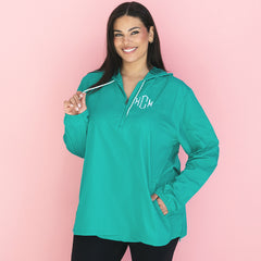 girl wearing teal monogrammed pullover rain jacket